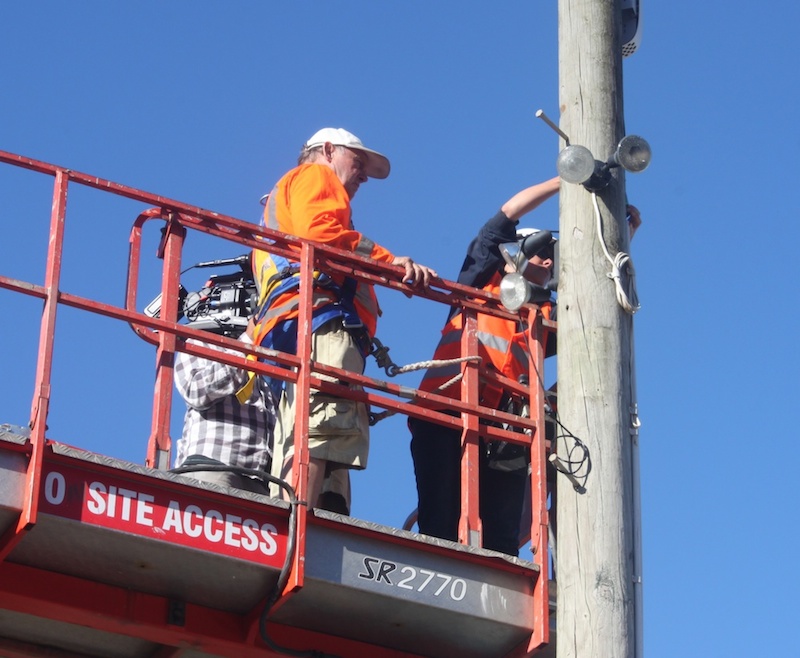 Two men setting up cables
