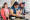 Three people smiling while baking