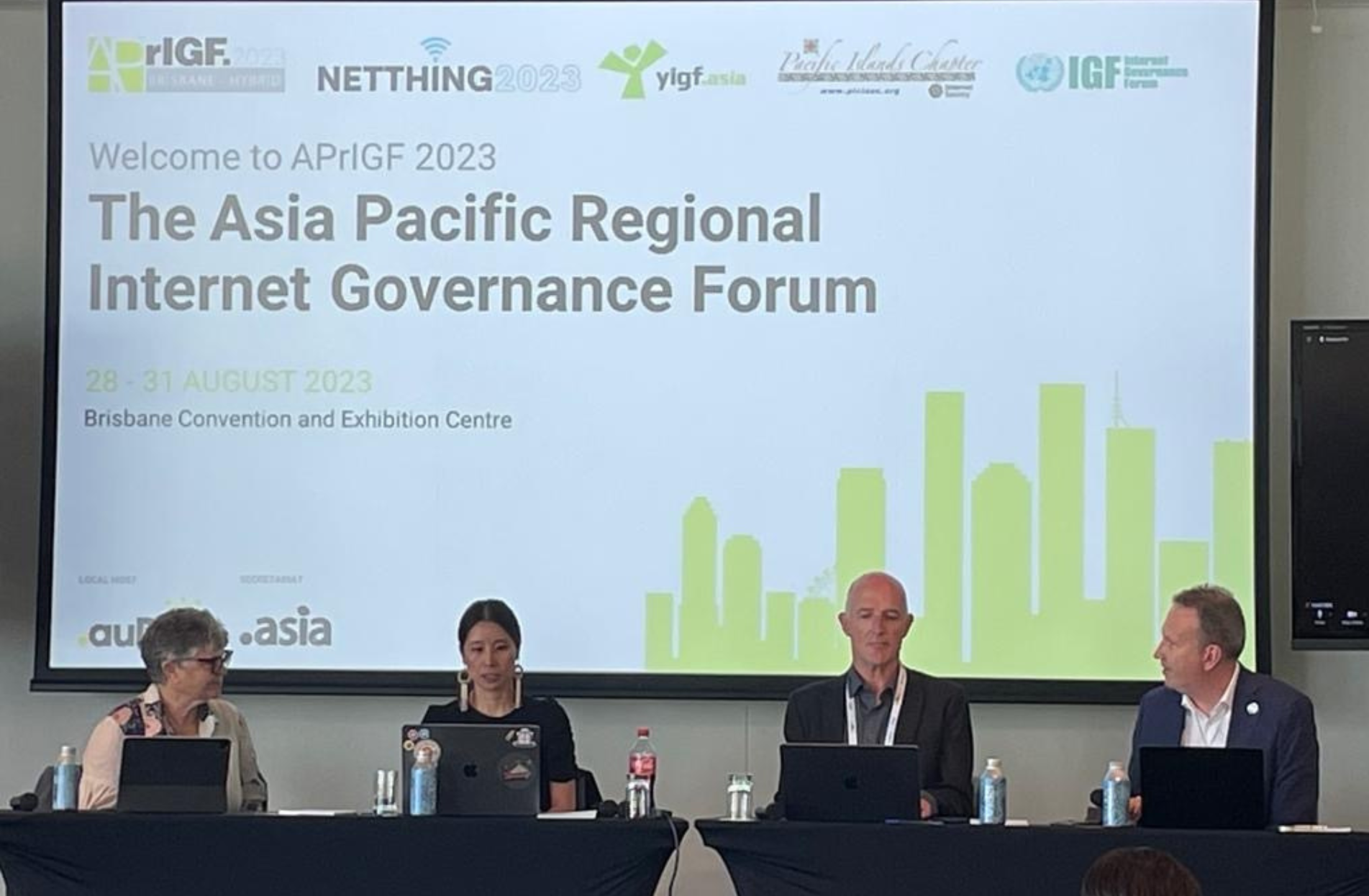 Four panelists sitting at a table